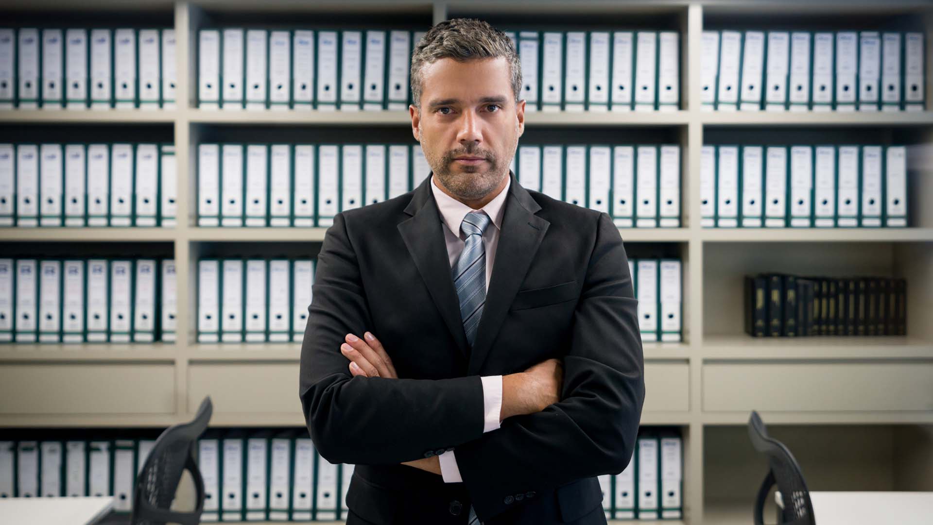 Man of integrity standing in front of accounting records kept meticulously